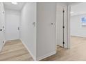 Bright hallway featuring modern flooring, white walls, and access to various rooms at 8820 Yardley Ct # Apt 309, Indianapolis, IN 46268