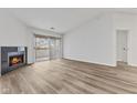 Open-concept living room boasts a fireplace, large windows, and a sliding glass door to a balcony at 8820 Yardley Ct # Apt 309, Indianapolis, IN 46268