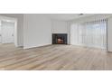 Spacious living room showcases a fireplace, large windows, and modern flooring at 8820 Yardley Ct # Apt 309, Indianapolis, IN 46268