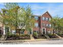 Beautiful brick townhomes with well-kept lawns, classic black shutters, and fresh landscaping at 918 Rosalind Pl, Carmel, IN 46032