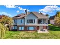 Two-story home featuring brick and siding, a screened porch, a patio, and a spacious backyard with mature trees at 11832 Stoney Bay Cir, Carmel, IN 46033