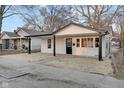A well-maintained home with a cozy front porch, fresh paint and a neatly kept yard at 1209 N Centennial St, Indianapolis, IN 46222