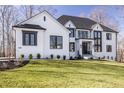 Beautiful white brick home featuring striking black windows and a green lawn at 1355 Forest Hills Dr, Westfield, IN 46074