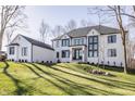 Charming white brick home with dark trim and a lush green lawn at 1355 Forest Hills Dr, Westfield, IN 46074