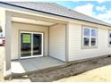 Covered patio space featuring a sliding glass door and bright windows, perfect for outdoor living and entertainment at 1419 School Bell Dr, Greenwood, IN 46143