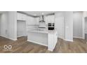 Bright, open kitchen with island, hardwood floors and stainless appliances at 14859 Amber Light Dr, Westfield, IN 46074