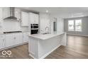 Modern kitchen featuring white cabinets, stainless steel appliances, and a large center island at 14859 Amber Light Dr, Westfield, IN 46074
