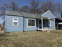 Light blue exterior with updated windows and well-maintained landscaping at 1618 W 17Th St, Anderson, IN 46016