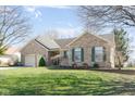 Lovely home with green shutters, brick exterior, and a well-manicured lawn and landscaping at 1667 Decourcy Ct, Franklin, IN 46131