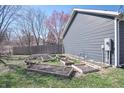 Well maintained backyard features mulched garden beds, and established trees at 1755 Pinion Ct, Columbus, IN 47201