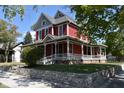 Beautiful two-story red home with a classic wrap-around porch at 189 S Jefferson St, Martinsville, IN 46151