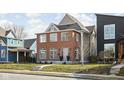 Attractive two-story brick home with a well-kept lawn and inviting curb appeal in a neighborhood setting at 2031 Central Ave, Indianapolis, IN 46202