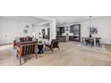Open concept living room seamlessly connects the kitchen and dining areas with light wood flooring at 2031 Central Ave, Indianapolis, IN 46202