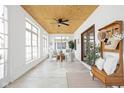 Bright sunroom with large windows, comfortable seating, and a decorative ceiling fan at 2031 Central Ave, Indianapolis, IN 46202