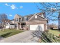 Exterior view of a two-story brick home with a two-car garage and concrete driveway leading up to it at 281 Dovetree Dr, Danville, IN 46122