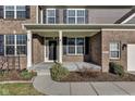Inviting front porch featuring classic brickwork, white columns, and a charming front door with a wreath at 281 Dovetree Dr, Danville, IN 46122