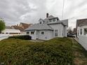 Side view of a well-maintained home with a gray exterior and manicured landscaping at 367 W Broadway St, Shelbyville, IN 46176