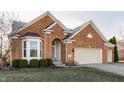 Beautiful brick home with a two-car garage, a manicured lawn, and a bay window at 405 Letterman Dr, Brownsburg, IN 46112