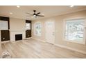 Bright living room featuring a fireplace, new flooring, and lots of natural light at 4504 Winthrop Ave, Indianapolis, IN 46205