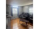Bright living room features hardwood floors, and large windows for an abundance of natural light at 4930 Candy Spots Dr, Indianapolis, IN 46237