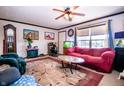 Inviting living room with a ceiling fan, a decorative rug, and an aquarium at 5010 S 550 W, Columbus, IN 47201