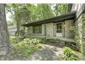 Charming covered front porch with stone facade and lush landscaping at 569 King Dr, Indianapolis, IN 46260