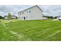 Spacious backyard with a well-maintained lawn, perfect for outdoor activities and relaxation at 5908 Agogo Way, Greenwood, IN 46143