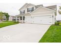 Charming two-story home with a well-maintained lawn and an attached two-car garage at 5908 Agogo Way, Greenwood, IN 46143