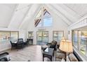 Inviting living room featuring vaulted ceilings, natural light, and scenic lake views from multiple windows at 6198 Grosbeak Dr, Nineveh, IN 46164
