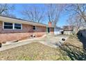 The house features a brick exterior with a patio perfect for outdoor entertaining at 7953 Forest Park Dr, Indianapolis, IN 46217