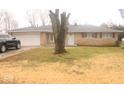Charming single-story brick home with a well-manicured front lawn and mature tree at 8137 S Delaware St, Indianapolis, IN 46227