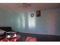 Bright living room featuring hardwood floors, light blue walls, and a ceiling fan at 8137 S Delaware St, Indianapolis, IN 46227