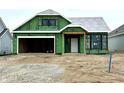 New construction home features an attached two car garage and a covered front porch at 9163 Bryce Cir, Zionsville, IN 46077
