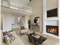 Open-concept living area with fireplace, loft, and comfortable seating at 9459 Wimbledon Ct, Indianapolis, IN 46250