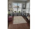 Bright, plant-filled living room with large windows and hardwood floors, creating a cozy ambiance at 1460 Tuscany Dr, Greenwood, IN 46143