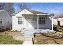 Inviting front porch and siding details add curb appeal to this charming home at 1622 N Linwood Ave, Indianapolis, IN 46218