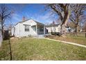 Quaint home with a lush green lawn and large trees providing shade at 1622 N Linwood Ave, Indianapolis, IN 46218