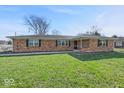 Charming single-story brick home featuring a well-maintained lawn and mature tree at 1721 Rachel Dr, Plainfield, IN 46168