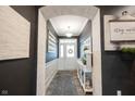 Inviting entryway with decorative archway, neutral walls, and views of front door at 19252 Chestnut Grove Ln, Noblesville, IN 46062