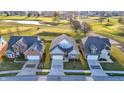 Aerial view of houses with manicured lawns and mature trees in a serene setting at 2199 Somerset Dr, Franklin, IN 46131
