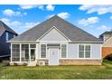 Back exterior features screened porch and views of the lawn at 2199 Somerset Dr, Franklin, IN 46131