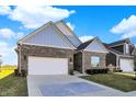 Beautiful brick home with a spacious two-car garage and meticulously maintained landscaping at 2199 Somerset Dr, Franklin, IN 46131