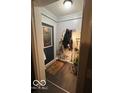 Functional entryway with tiled floor, coat rack, and stylish accents at 245 E Plum St, Anderson, IN 46012
