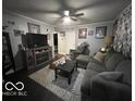 Inviting living room with dark floors, plush seating, and a cozy fireplace at 245 E Plum St, Anderson, IN 46012
