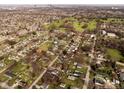 High aerial view of residential neighborhood with green spaces and distant city skyline at 3014 Alice Ave, Indianapolis, IN 46237