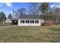 Inviting single-story home featuring a bright sunroom and a cozy wooden deck at 3018 Alice Ave, Indianapolis, IN 46237