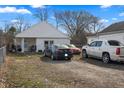 Cozy single-story home with a front yard, gravel driveway, and multiple cars parked out front at 3027 Alice Ave, Indianapolis, IN 46237