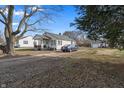 Quaint home with a detached garage, a blue car parked in the driveway, and a spacious backyard at 3039 Alice Ave, Indianapolis, IN 46237