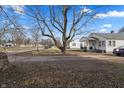Residential property with a large bare yard, a mature tree, and views of the surrounding neighborhood at 3039 Alice Ave, Indianapolis, IN 46237
