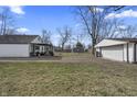 Large backyard with a detached garage and patio area, ideal for relaxation and outdoor entertainment at 3104 Alice Ave, Indianapolis, IN 46237
